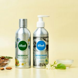 Natural hair care products featuring goat milk shampoo and hair growth oil on a yellow background.